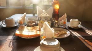 a table topped with plates of food on a table at K & K INN in Cherrapunji
