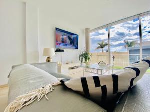 a living room with a couch and a large window at Villa Cristallo en Costa Adeje in Playa de las Americas