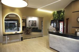 a lobby with a counter and a waiting room at Savana Park Hotel in Andradina