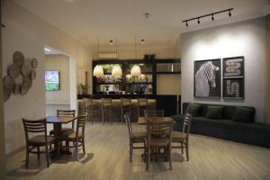 a living room with a couch and a table and chairs at Savana Park Hotel in Andradina
