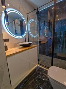 a bathroom with a sink and a mirror at Apartament Blue BB in Bielsko-Biała
