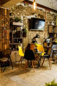 Panela Coffee Hostel في ميديلين: غرفة بها كراسي وطاولة وتلفزيون