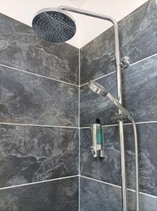 a shower with a shower head in a bathroom at Victorian Renovation Room 6 in Liverpool