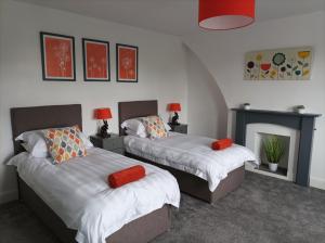 a bedroom with two beds and a fireplace at Victorian Renovation Room 6 in Liverpool