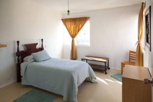 Schlafzimmer mit einem Bett, einem Fenster und einem Tisch in der Unterkunft Sunset Included in your stay !!! in Tijuana