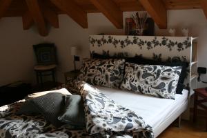 a living room with a couch with pillows on it at Bernina Express Eco Rooms&Breakfast in Tirano