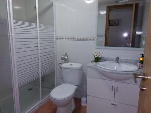 a white bathroom with a toilet and a sink at Casas de Maragouzos in Silleda +27 photos