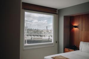 a window in a bedroom with a view of a bridge at Hotel Dali Plaza Ejecutivo in Guadalajara