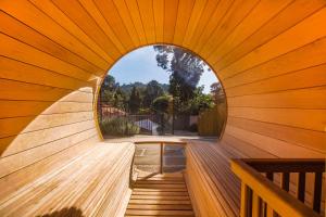 an inside view of a sauna with a circular window at Pousada Boutique Vilage de Minas in Monte Verde