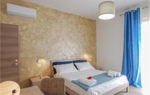 a bedroom with a bed with two towels on it at 2 Bedroom Beautiful Home In Corridonia in Corridonia