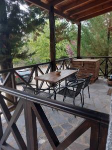 a wooden table and chairs on a patio at Vitina Stone House in Vitina