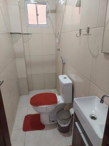 a small bathroom with a toilet and a sink at Bonito é ser Feliz in Recife +18 photos