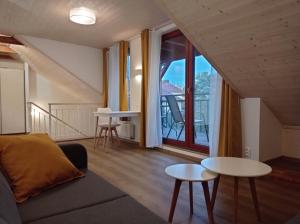 a living room with a couch and a table at Apartmán Kollarovi in České Budějovice