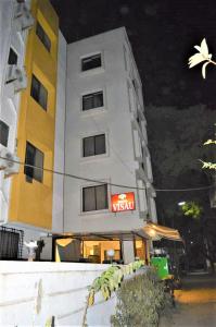 a building with a sign on the front of it at Hotel Visau,Shirdi in Shirdi