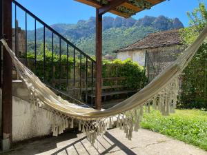 a hammock hanging from a porch with a view at CASA SENERA in Santa Cruz de la Serós