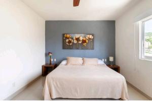 a bedroom with a white bed and two tables at Lindo Condominio Acapulco Dorado Amaras ubicación. in Acapulco +63 photos