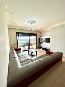 a large couch in a living room with a view of the ocean at Funtastic Villa With Pool in Albufeira