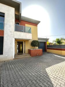 a house with a brick driveway in front of it at Funtastic Villa With Pool in Albufeira
