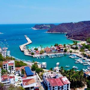 an aerial view of a harbor with boats in the water at Departamento ELSA. La Crucecita, Huatulco. in Santa Cruz Huatulco