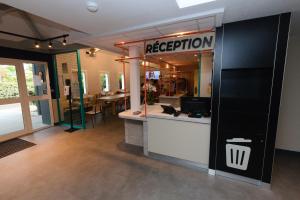a store with a robbery sign on the wall and a counter at ibis Budget La Teste Bassin d'Arcachon in La Teste-de-Buch