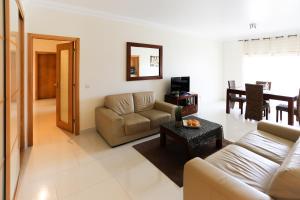 a living room with a couch and a table at High quality T2 apartment In SMP in São Martinho do Porto