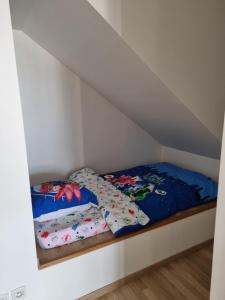 a bed with two pillows on it in a room at Ravissant Studio avec parking privé et jardin in Rueil-Malmaison