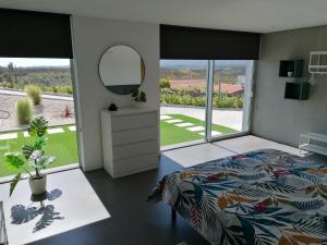 a bedroom with a bed and a mirror at "Villa Carpe Diem" Country house in Cambarinho +77 photos