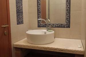a white sink in a bathroom with a mirror at negev ein habsor עין הבשור דרום in Ein HaBesor +19 photos