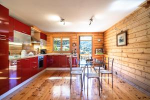 a kitchen with wooden walls and a table and chairs at Luxury Chalet Vila on Mountain Top with great view in Kalavrita