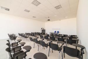 an empty room with chairs and a white wall at Tenuta Gurgo in Bitonto