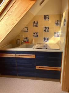 a small kitchen with a sink and a staircase at Apartment mit Ausblick im Dresdner Südwesten in Dresden