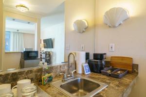 a kitchen counter with a sink and a mirror at Studio Unit at the Royal Garden, in Waikiki ワイキキ・ロイヤルガーデン in Honolulu