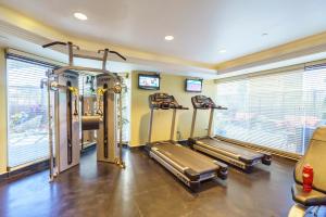 a gym with two treadmill machines in a room with windows at Studio Unit at the Royal Garden, in Waikiki ワイキキ・ロイヤルガーデン in Honolulu