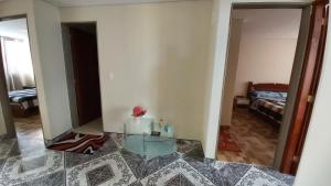 a living room with a glass table and a mirror at Edificio K&C in Sogamoso