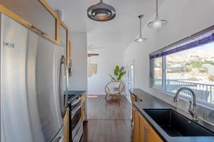 a kitchen with a sink and a window at Desert Hot Springs Inn in Desert Hot Springs