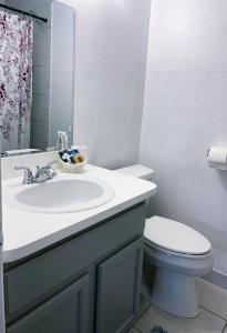 a bathroom with a sink and a toilet at Hello Sunshine 321... Lift Off in Titusville