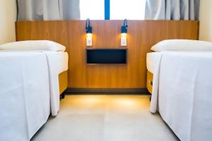 a room with two beds in a room with lights at salinas premium resort in Salinópolis