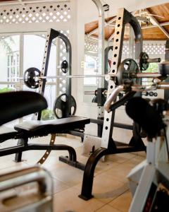 a gym with several tread machines in a room at Vf Hotel in Cuernavaca