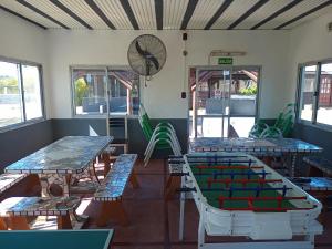 a room with tables and chairs and a pool table at Complejo Sagitario in Gualeguaychú