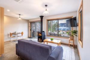 a living room with a couch and a fireplace at Freycinet Stone Studio 7 - Quartz in Coles Bay