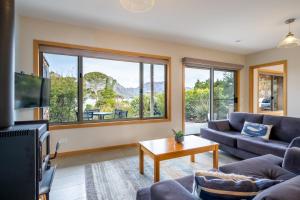 a living room with a couch and a tv at Freycinet Stone Studio 3 - Feldspar in Coles Bay