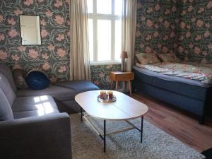 a living room with a couch and a table at Holiday home RONNEBY IX in Ronneby