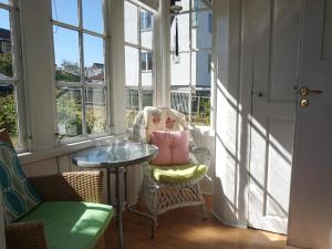a balcony with a table and a chair and windows at Holiday home RONNEBY IX in Ronneby