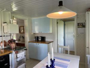 a kitchen with a table with two candles on it at Holiday home GRÄSTORP in Grästorp