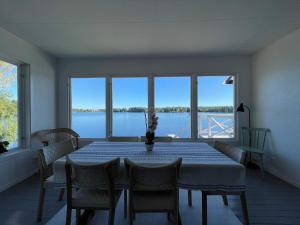 a dining room with a table and a view of the water at Holiday home BRUZAHOLM III in Bruzaholm