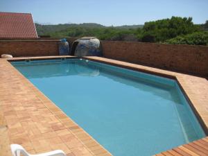 a large swimming pool on top of a building at Dolphins View Self Catering Guesthouse in Duiwerivier