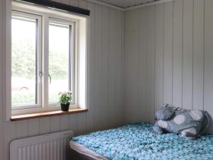 a bedroom with a bed with a teddy bear on it at Holiday home Tvååker III in Tvååker