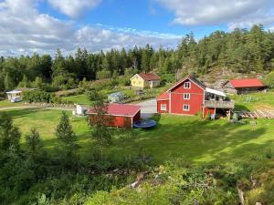 an aerial view of a red barn and a house at 2 person holiday home in HENÅN in Henån