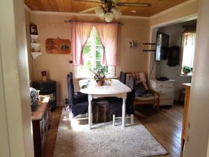 a living room with a table and a window at Holiday home RAMSJÖ II in Ramsjö