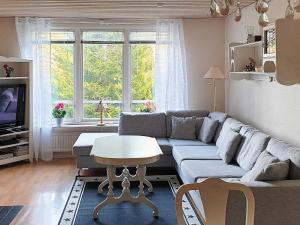 a living room with a couch and a table at Holiday home Annerstad in Skärseryd